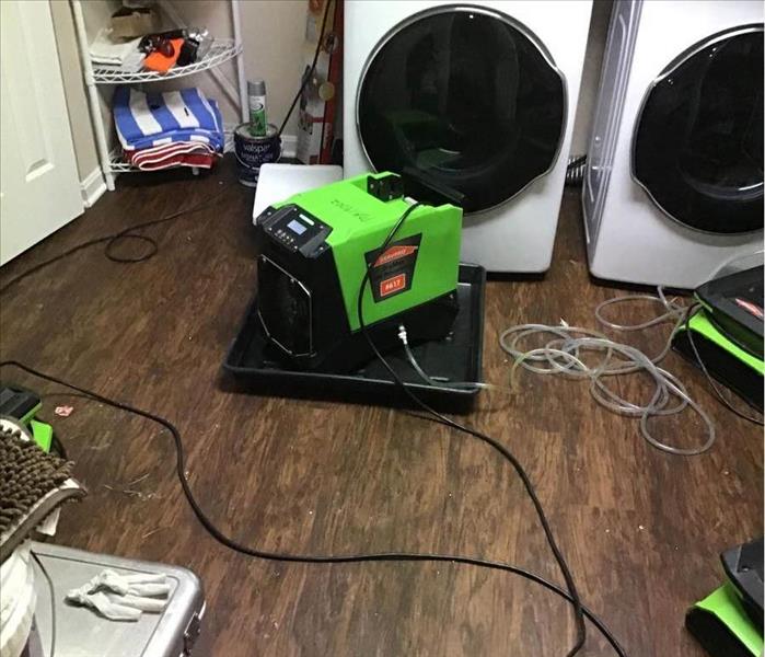 air movers in front of a washer and dryer 