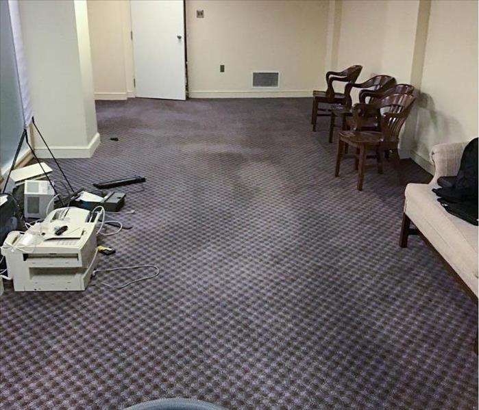 Water damage to carpet in waiting room of bank