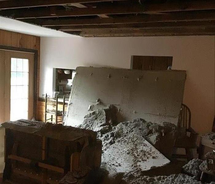 rubble after the ceiling caved in in a living room 